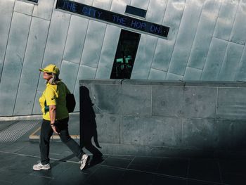 Full length of woman standing by railing