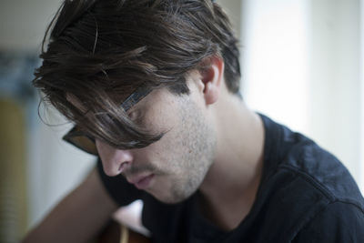 Close-up of young man looking at home