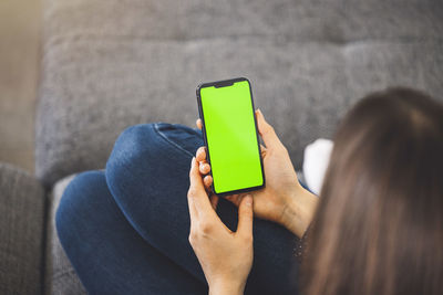 Midsection of woman using mobile phone