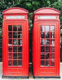 Red telephone booth against window