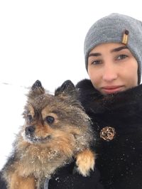 Portrait of smiling young woman in snow