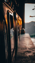 Close-up of train against sky during sunset