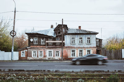 Building by road against sky in city