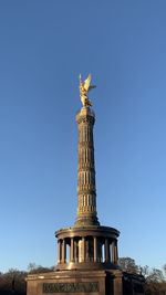 Low angle view of statue against blue sky