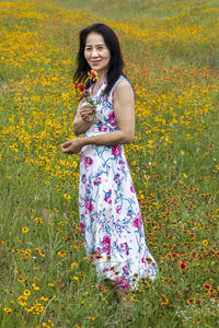 Happy woman standing on field