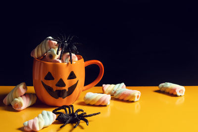 Close-up of cupcakes on table against black background