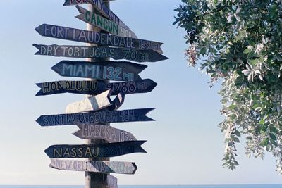 Low angle view of sign against clear sky