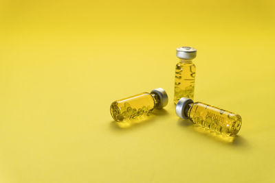 Close-up of bottle against yellow background