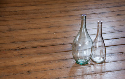 Glass bottles on hardwood floor