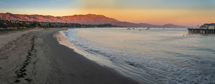 Scenic view of beach against sky during sunset