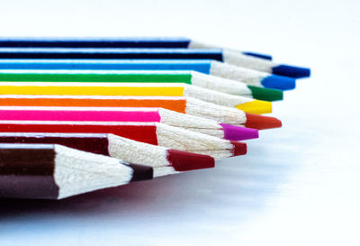 Close-up of multi colored pencils on white background