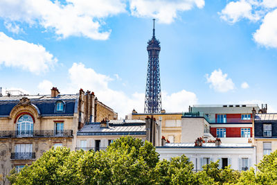 Low angle view of buildings against cloudy sky