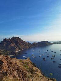 Padar island in the morning with many ships docked at the beach