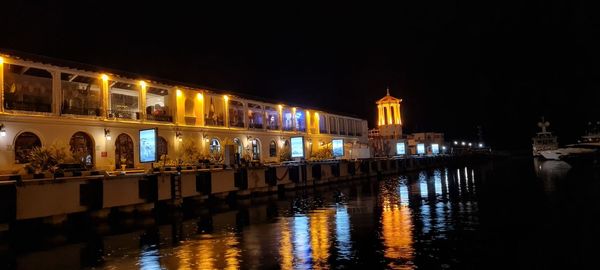 Reflection of illuminated buildings in water at night