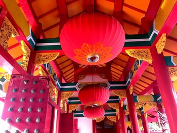 Low angle view of lanterns hanging on ceiling of building