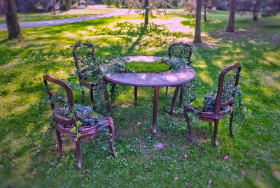 Empty chairs and table in park