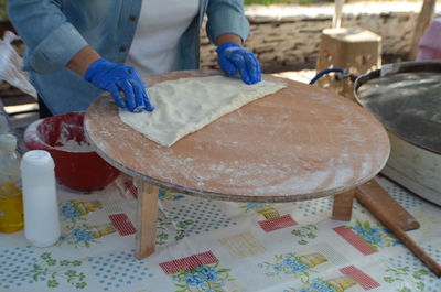 Close-up of person preparing food on table