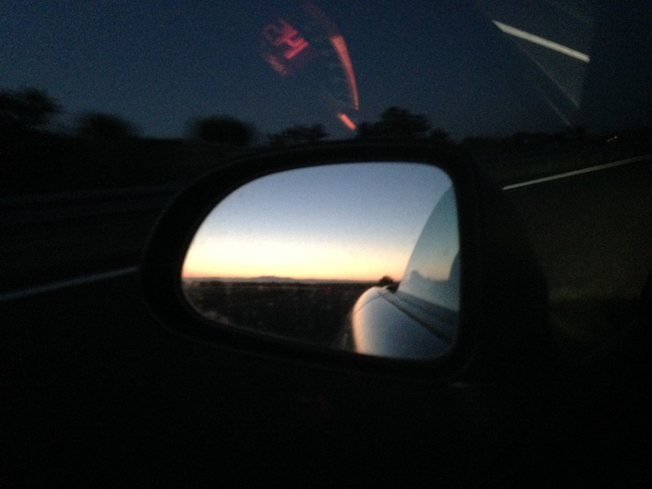 REFLECTION OF SIDE-VIEW MIRROR IN CAR