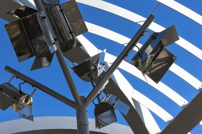 Low angle view of flags against clear blue sky