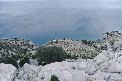 High angle view of rocks on sea shore