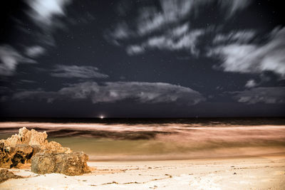 Scenic view of sea against sky at night