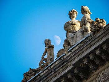 Low angle view of statue against blue sky