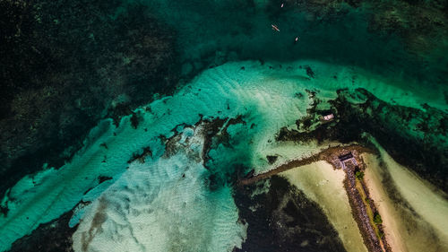 The photo captures a breathtaking view of a serene beach with crystal-clear waters.