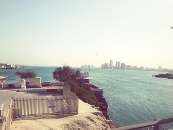 View of city by sea against clear sky