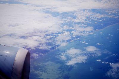 Cropped image of airplane wing over landscape