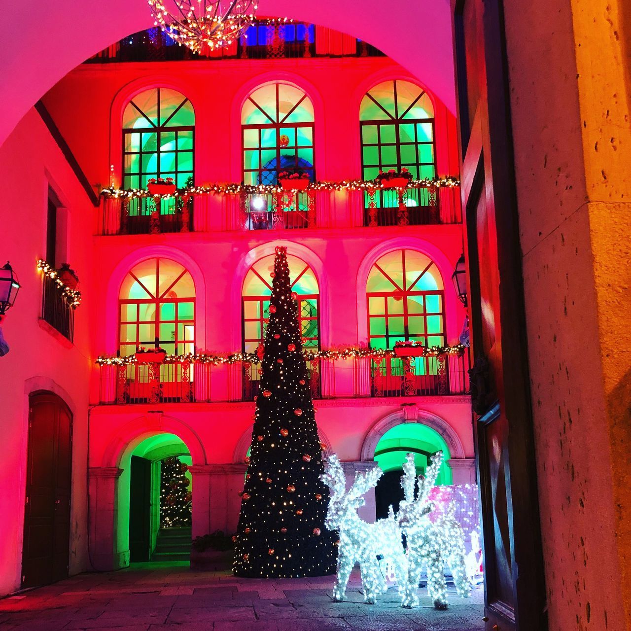 ILLUMINATED CHRISTMAS TREE AT BUILDING