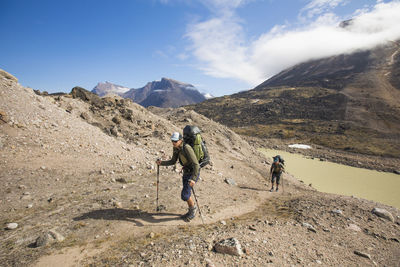 People on mountain against sky