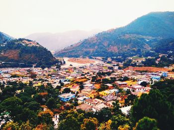 High angle view of townscape and mountains against sky