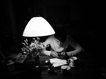 Woman sitting on table at home