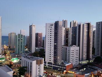 Buildings in city against clear sky
