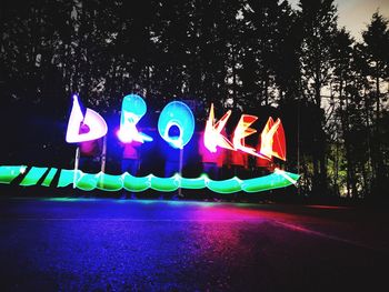 Illuminated light painting on tree at night