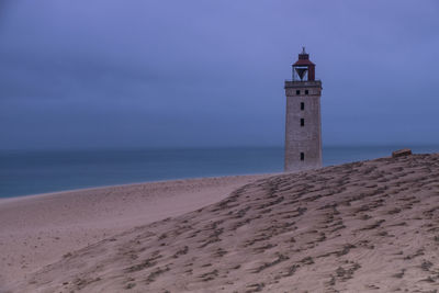 Lighthouse rubjerg knude at sunset on a stormy evening with dramatic sky