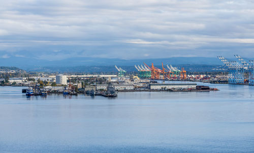 The wharf at the port of tacoma with many cranes for shipping.