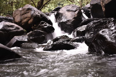 View of waterfall along rocks