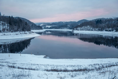 Scenic view of frozen lake against sky during winter