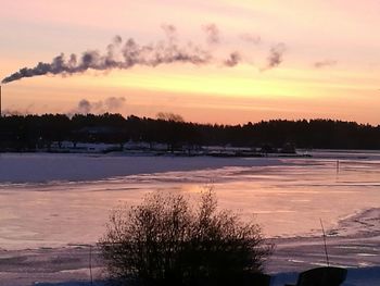 Scenic view of lake against sky at sunset