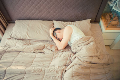 High angle view of mid adult man sleeping on bed at home