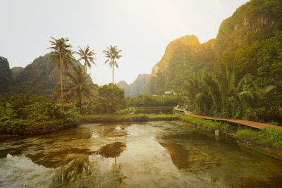 Scenic view of river amidst mountains against sky