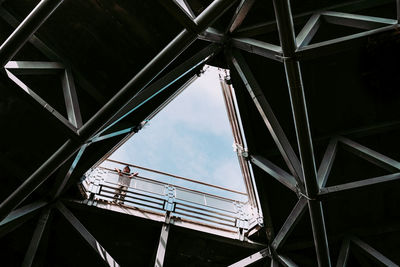 Low angle view of boy on bridge seen through ceiling