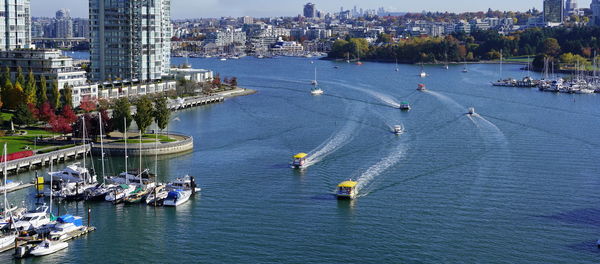 High angle view of people by river in city