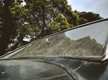 Close-up of car on road against sky