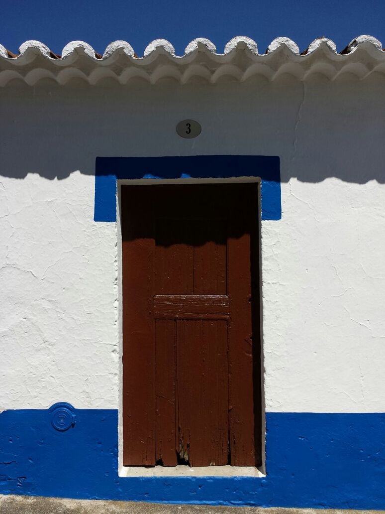 building exterior, architecture, built structure, house, blue, door, residential structure, closed, wood - material, clear sky, roof, window, day, protection, residential building, safety, outdoors, sunlight, wooden, no people