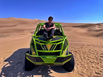 Buggy dune ride in huacachine desert. senior woman sitting on a quad