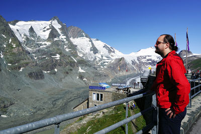 Man on snowcapped mountain against sky