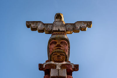 Low angle view of statue against blue sky