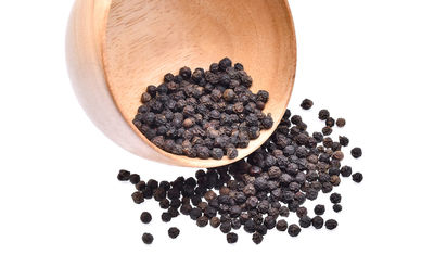 Close-up of pepper in bowl over white background